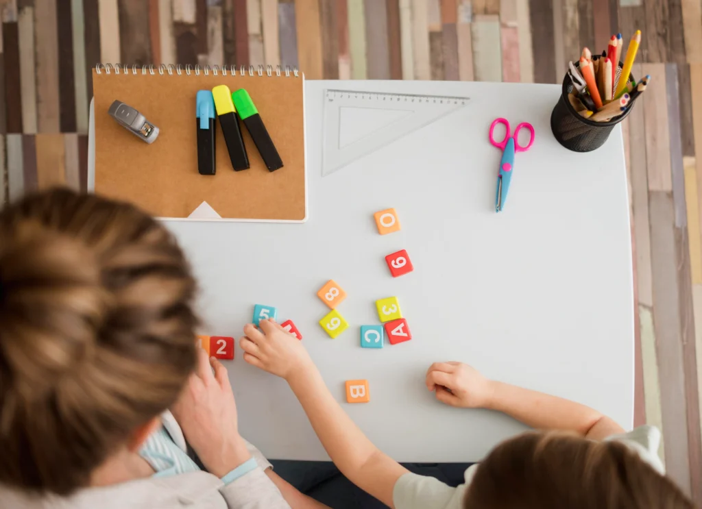 top view child tutor learning about numbers letters